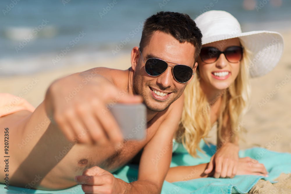 Fototapeta premium happy couple in swimwear walking on summer beach