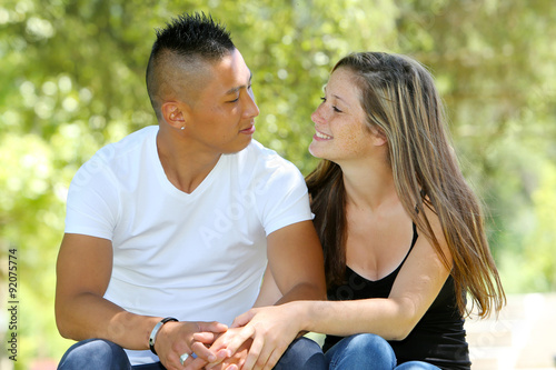 Mixed young couple in a park photo