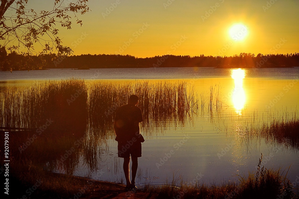 Fototapeta premium man watches the sun go down