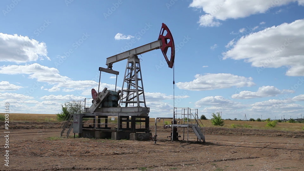 working oil pump on a background cloudy sky working oil pump on a background cloudy sky