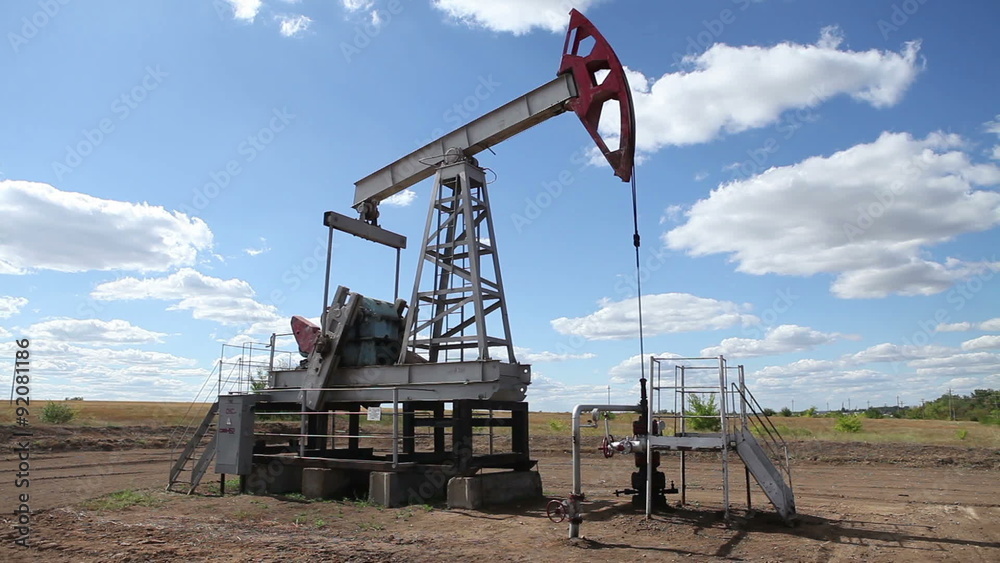 working oil pump on a background cloudy sky working oil pump on a background cloudy sky