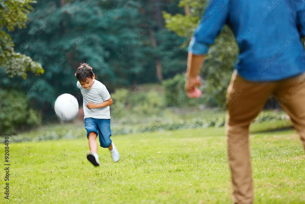 Summer football. Dad and son playing soccer. Summer football. Dad and son playing soccer.