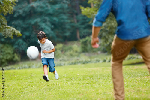 Summer football. Dad and son playing soccer. © puhhha
