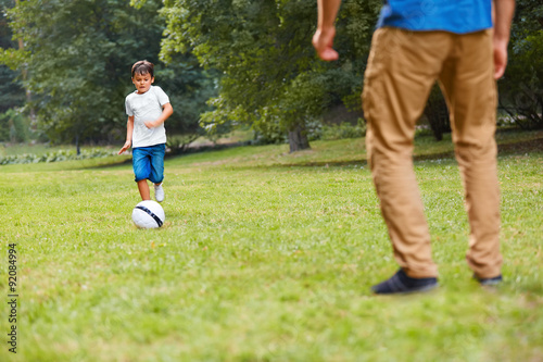 Family playing football. Father and son having fun.