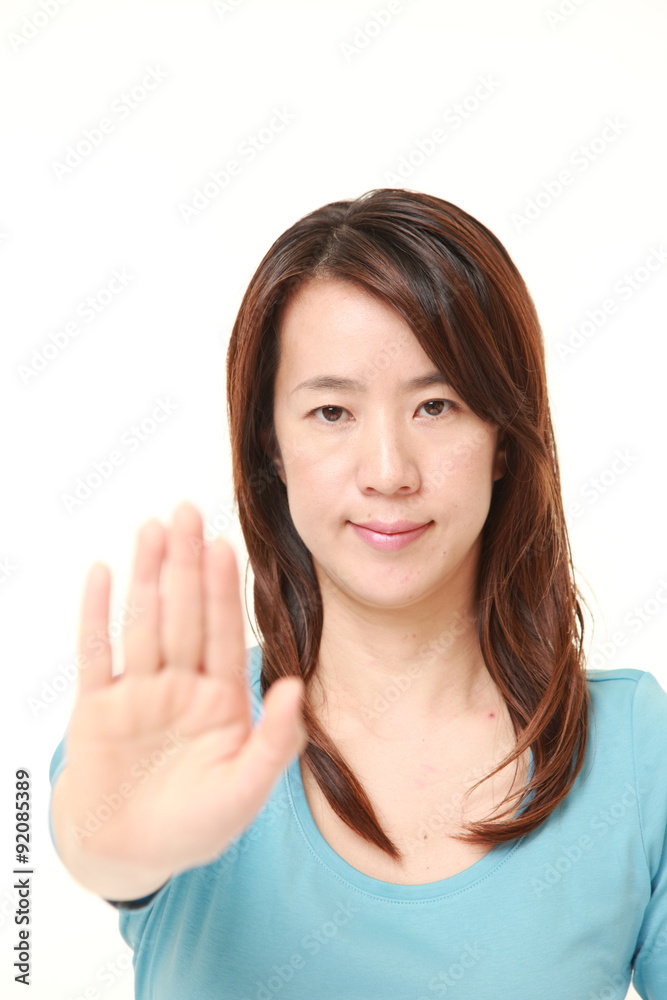 Japanese woman making stop gesture Japanese woman making stop gesture