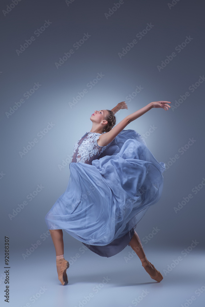 Fototapeta premium The beautiful ballerina dancing in blue long dress 