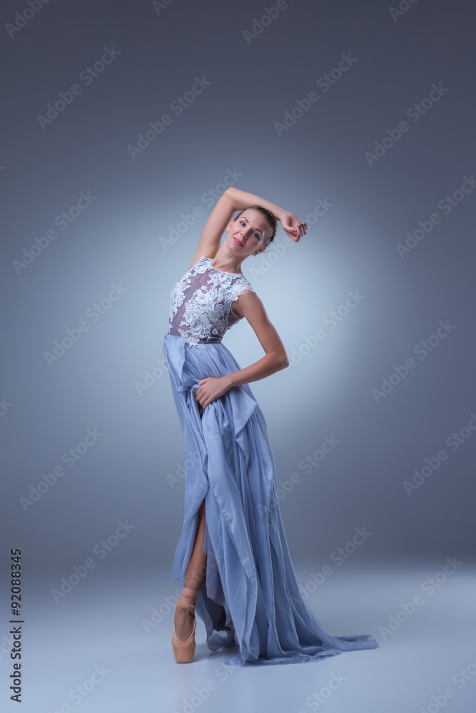 Fototapeta premium The beautiful ballerina dancing in blue long dress 