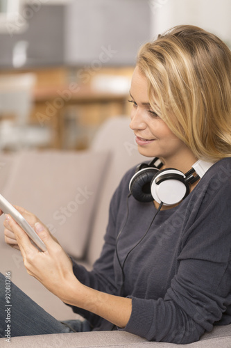 young woman listening music with digital tablet at home