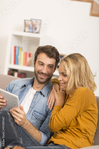 young couple using digital tablet at home © Atelier 211