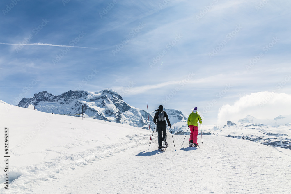 Women walking on ski in the snow mountain.