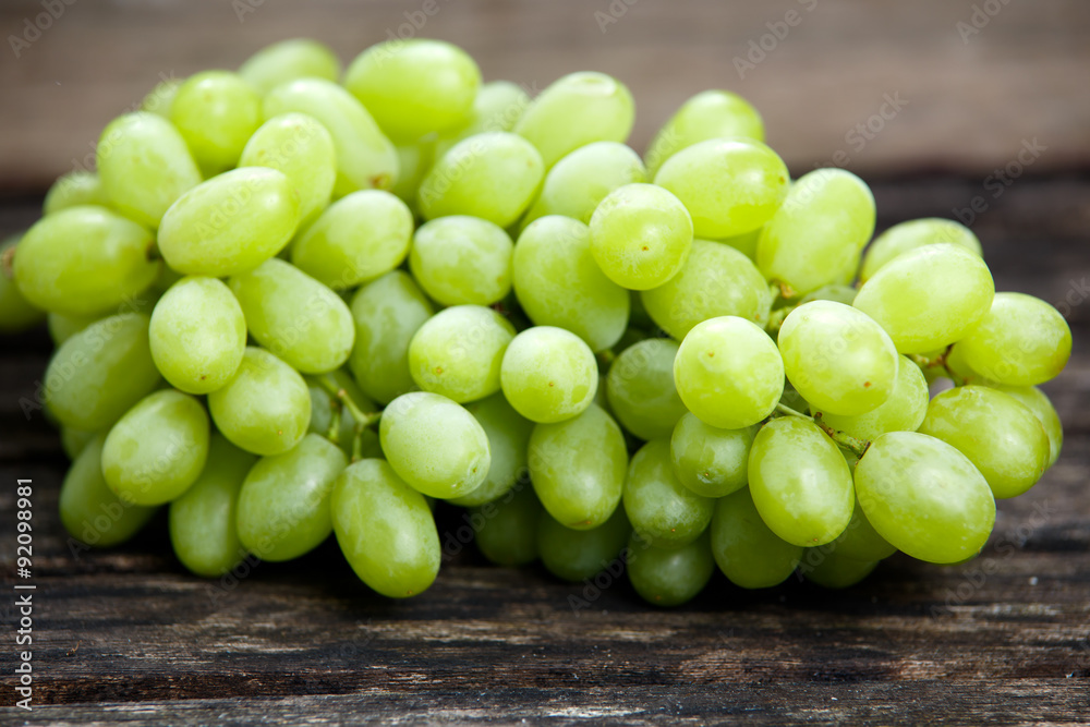 Green grape, close up on old wooden table. background. selected focus Green grape, close up on old wooden table. background. selected focus