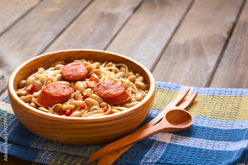 Traditional Chilean dish Porotos con Riendas, made of cooked beans, linguine, fried sausage, photographed with natural light (Selective Focus, Focus one third into dish) photo