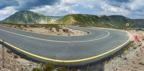 Panorama of winding asphalt highway at sunny day photo