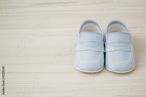 Pair of Classic Blue Baby Shoes on Grey background with Copy Space