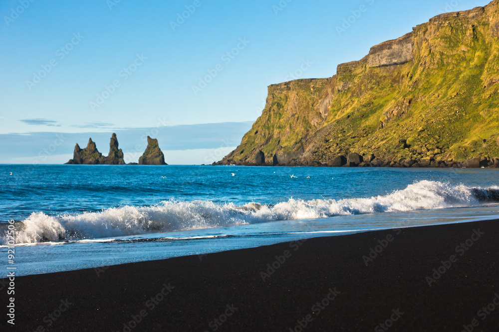 Waves at beautiful black volcanic sand beach in Vik at sunrise Waves at beautiful black volcanic sand beach in Vik at sunrise