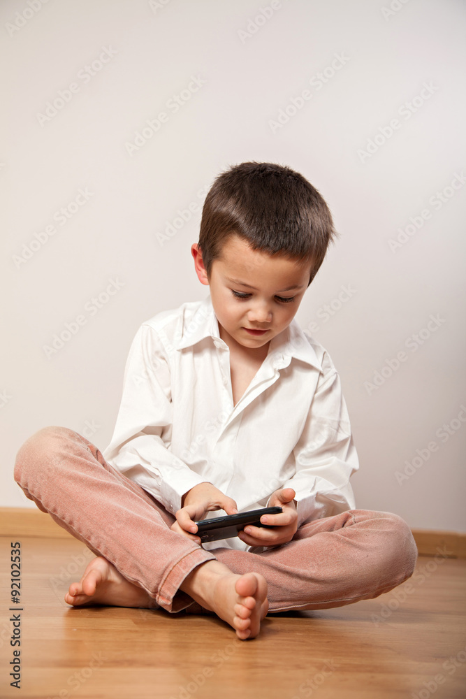 Little boy playing with smartphone Little boy playing with smartphone