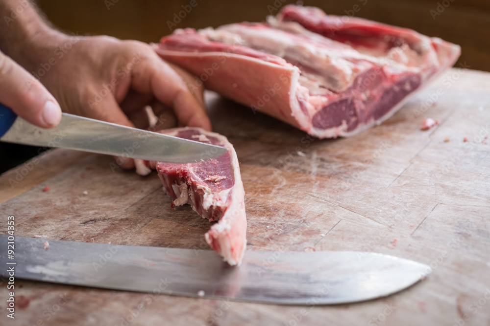 Close up of butcher cutting raw meat with a sharp knife Stock Photo | Adobe  Stock