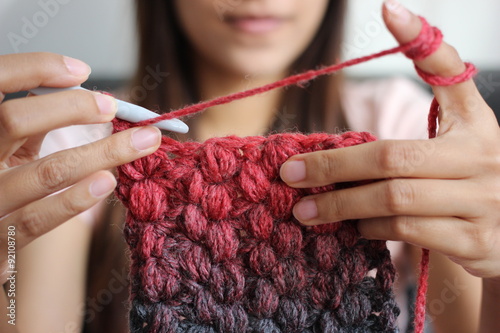 A girl showing how to crochet photo