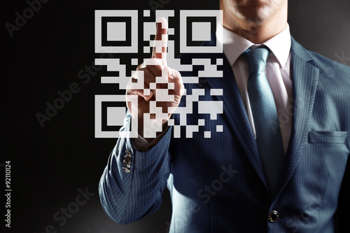 Man presses on QR code