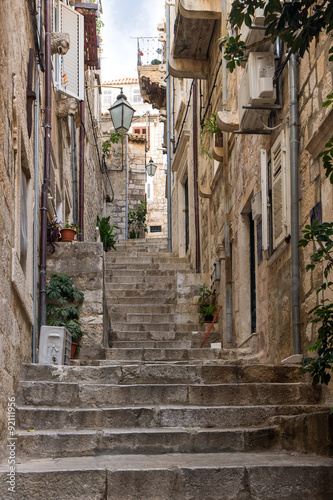 Narrow and empty alley and stairs at the Old Town in Dubrovnik, Croatia. © tuomaslehtinen