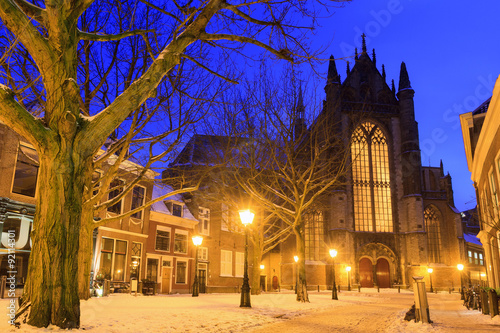 Hooglandsekerkgracht looking at the back of the Hooglandse church in Leiden at twilight in winter with snow in the Netherlands photo