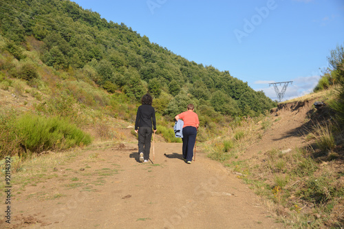 mujeres subiendo por un camino de montaña