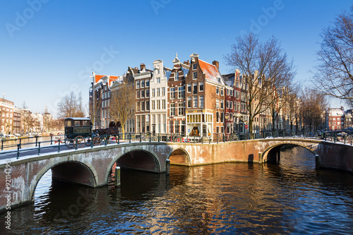Beautiful early morning winter view on one of the Unesco world heritage city canals of Amsterdam, The Netherlands. 