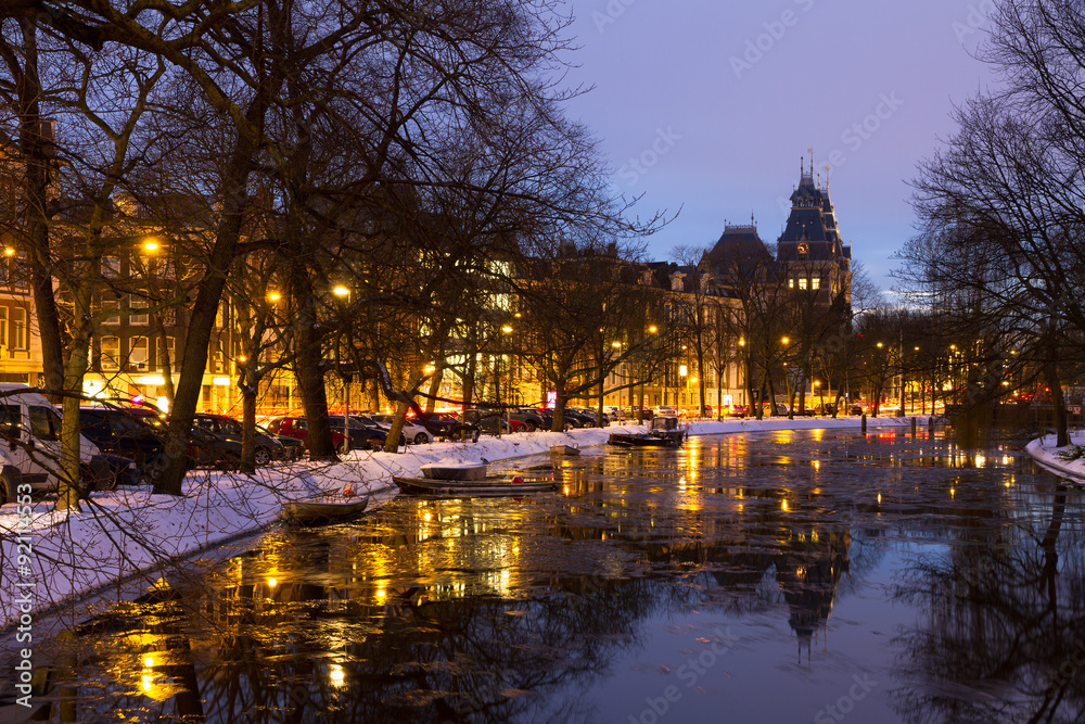 Beautiful twilight view in winter on the Stadhouderskade with the national state museum in the background in Amsterdam, the Netherlands