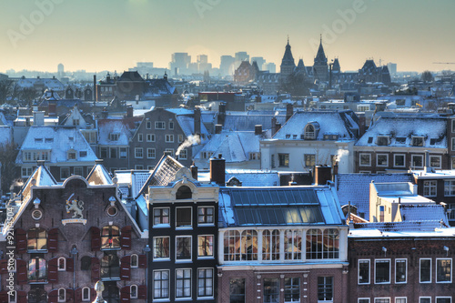 Photography Winter skyline of Amsterdam, the Netherlands, with snow on the rooftops