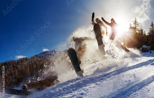 Powerful image of a snowboarder jumping over a kicker in the backcountry powder
