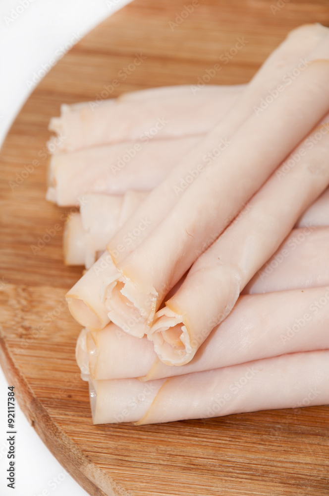 Naklejka premium Turkey breasts rolled on the wooden board