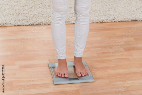 Woman Standing On Weighing Scale