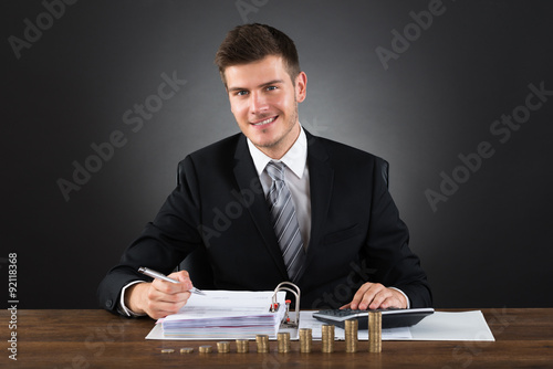 Businessman Doing Accounting At Desk