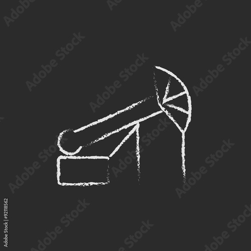 Pump jack oil crane icon drawn in chalk.