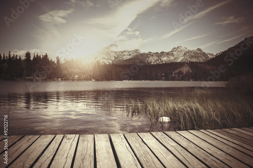 Retro style photo of alpine mountain lake
