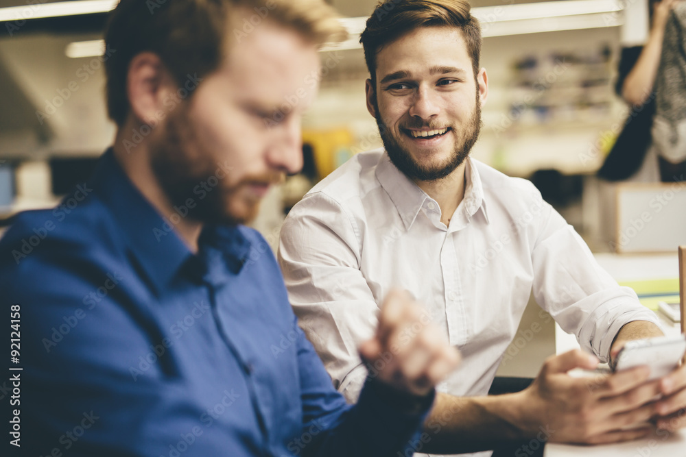 Obraz premium Handsome men working in an office