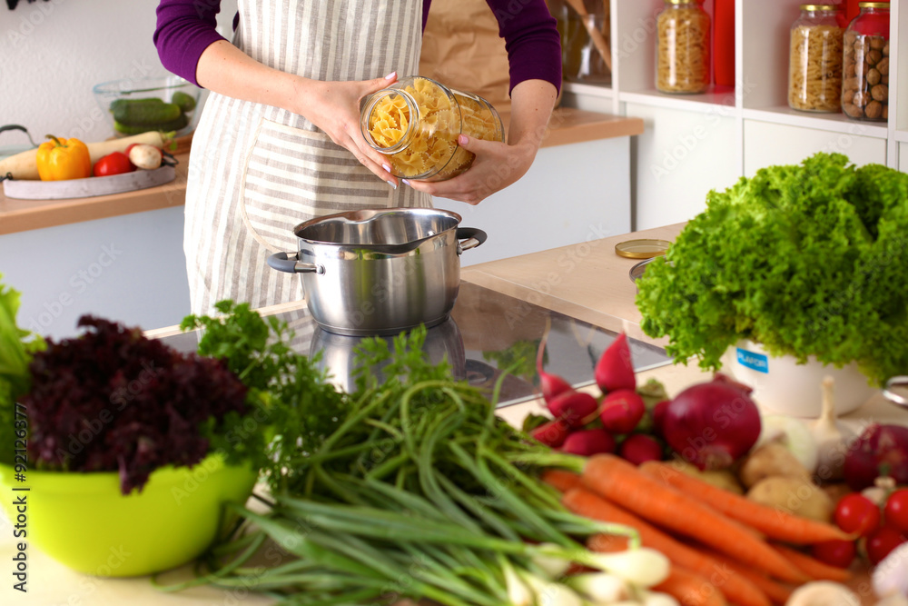Young Woman Cooking in the kitchen. Healthy Food Young Woman Cooking in the kitchen. Healthy Food