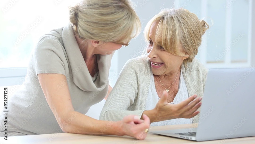 Senior women websurfing with laptop computer Senior women websurfing with laptop computer