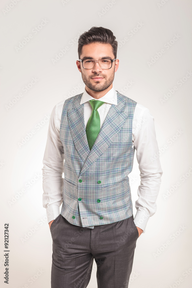 young business man standing with his hands in pockets young business man standing with his hands in pockets