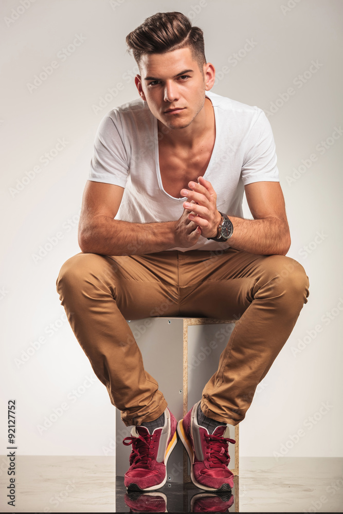 young sexy boy sitting and looking at the camera while touching Stock Photo  | Adobe Stock