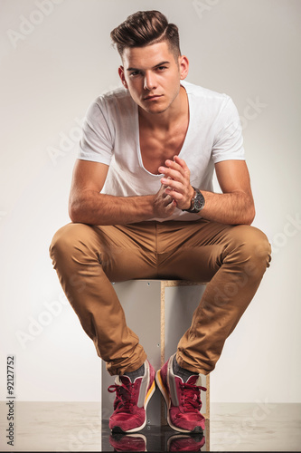 young sexy boy sitting and looking at the camera while touching Stock Photo  | Adobe Stock