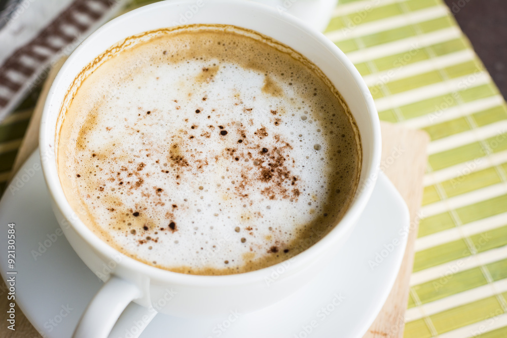 A cup of coffee or hot coffee on wooden table , soft-tone , focu A cup of coffee or hot coffee on wooden table , soft-tone , focu