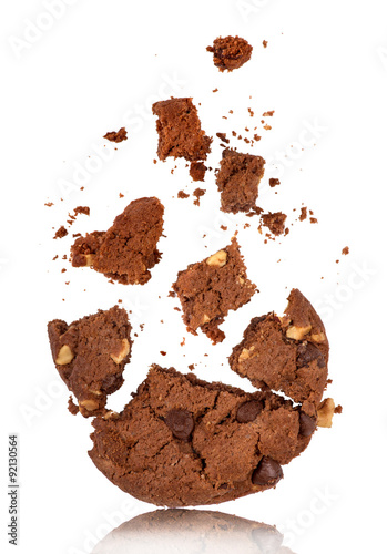 bitten into chocolate chip cookie with crumbs on white