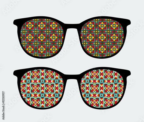 Retro sunglasses with ornament reflection in it.