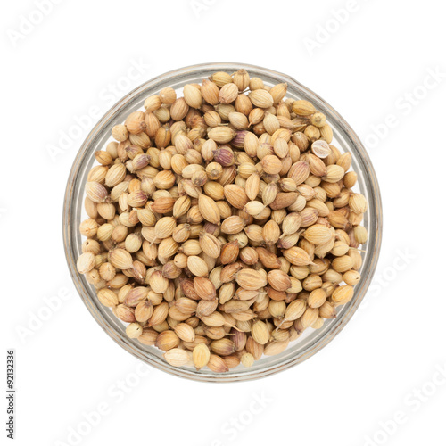 Top view of Organic Dried coriander seeds (Coriandrum sativum) in glass bowl isolated on white background.