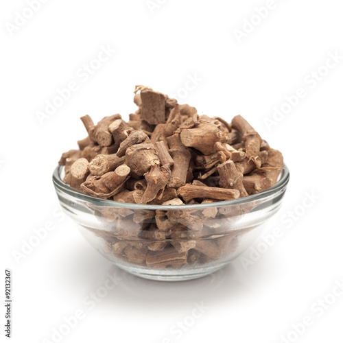 Front view of Organic Ganthoda or Long pepper Roots (Piper longum) in glass bowl isolated on white background.
