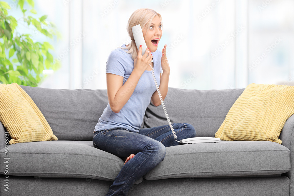 Surprised blond woman talking on the telephone Surprised blond woman talking on the telephone