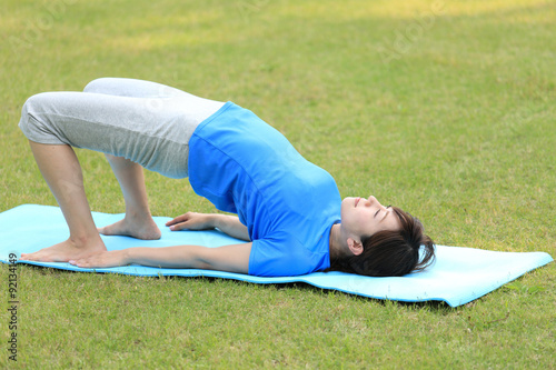 Japanese woman doing yoga Bridge Pose
