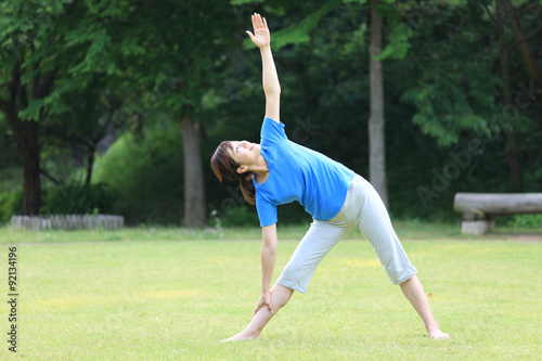 Japanese woman doing yoga triangle pose © jedi-master