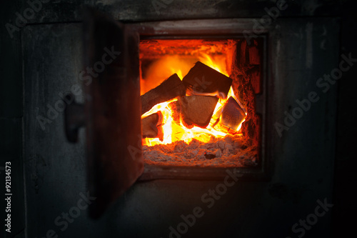 closeup of  wood stove with the burning firewood.